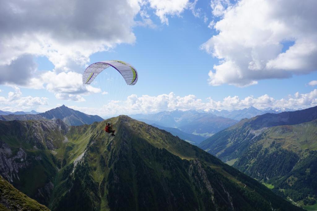 a person flying a kite on top of a mountain at Haus Staud in Schmirn