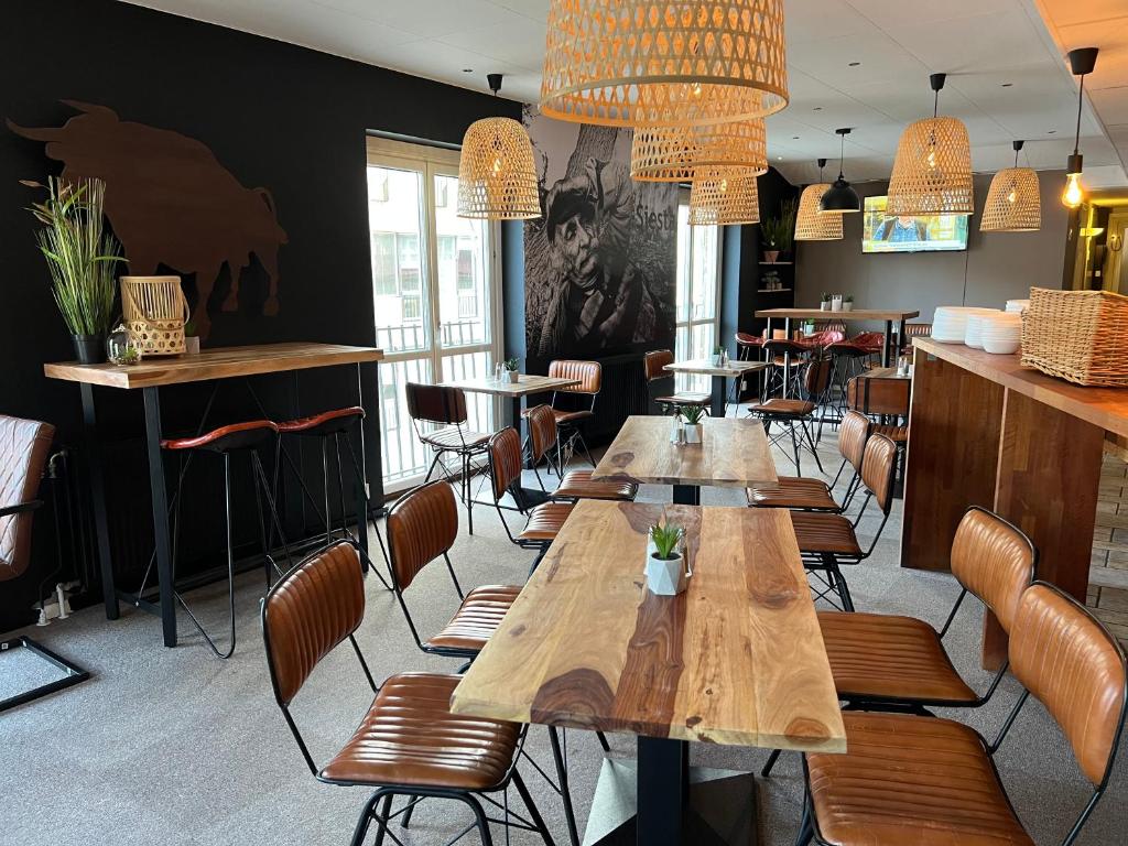 a dining room with wooden tables and chairs at Hotell Siesta in Karlskrona