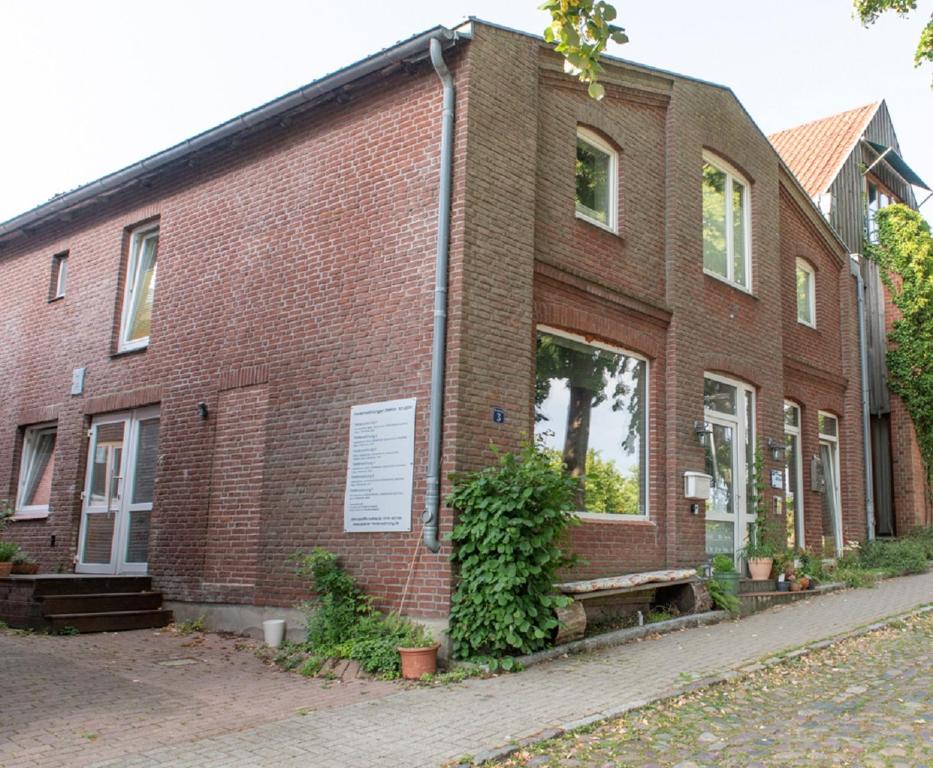 a brick building with a bench in front of it at Ferienwohnung Kruppa in Plön