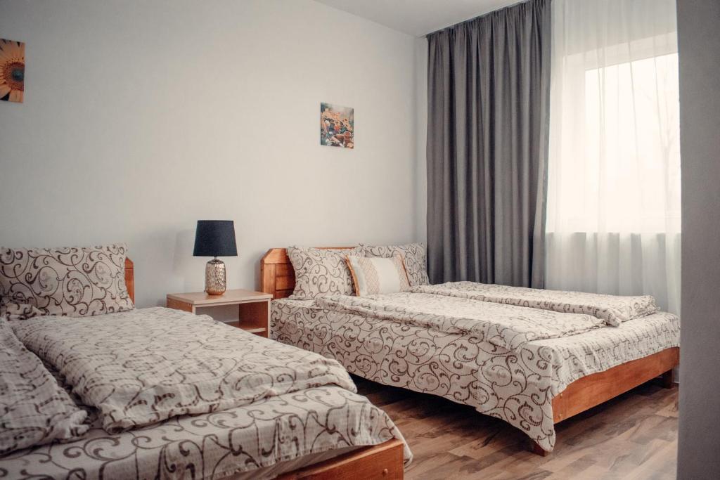 Katil atau katil-katil dalam bilik di Pensiunea turistica Retreat Belvedere