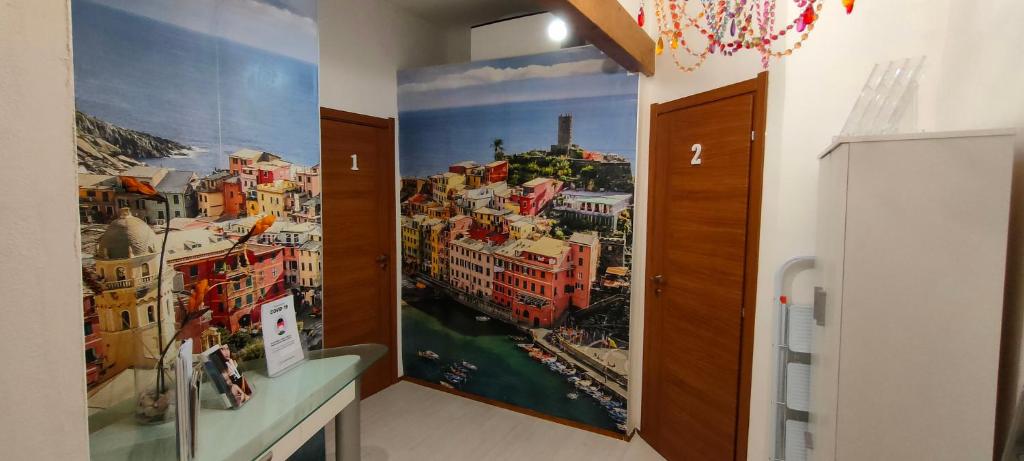 a room with a mural of a city on the wall at LA TANA DELLA VOLPE in La Spezia