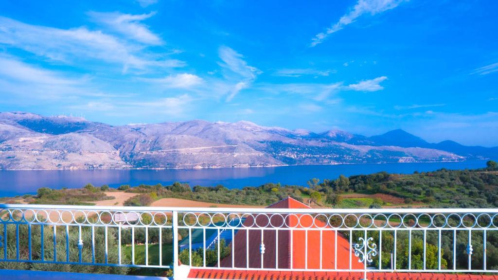 a view of the water and mountains from a balcony at Forestata Village in Lixouri