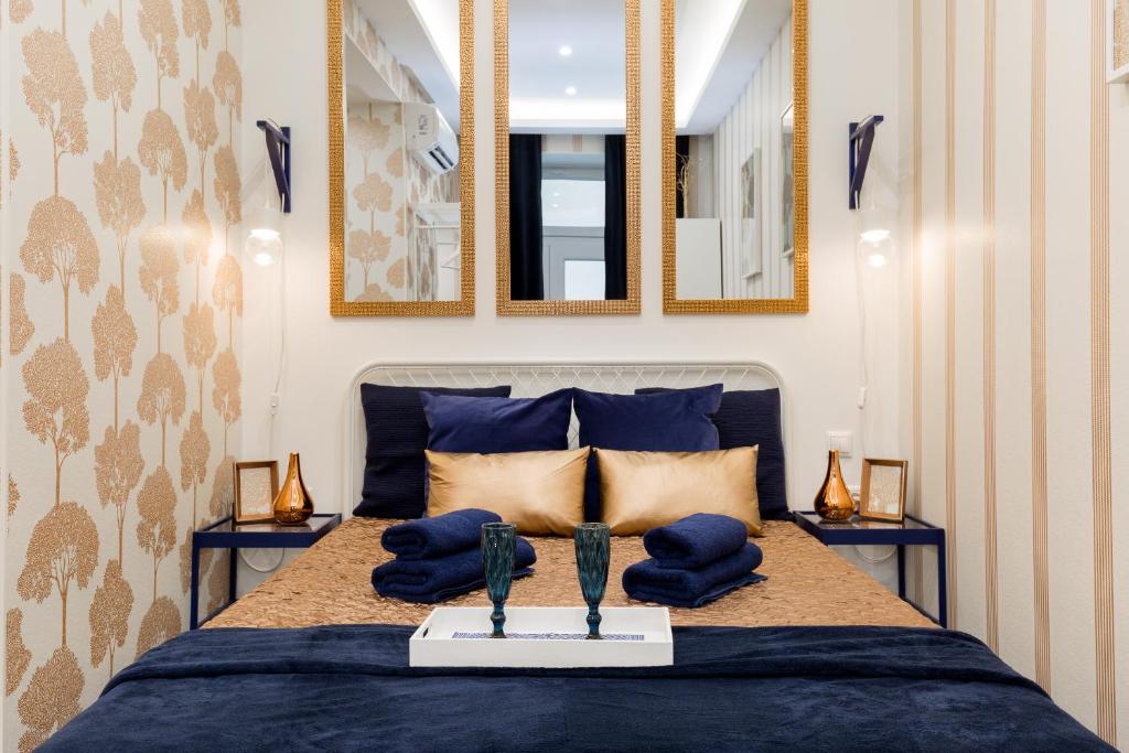 a bedroom with a bed with two awards on it at Budapest Holidays Fashion in Budapest