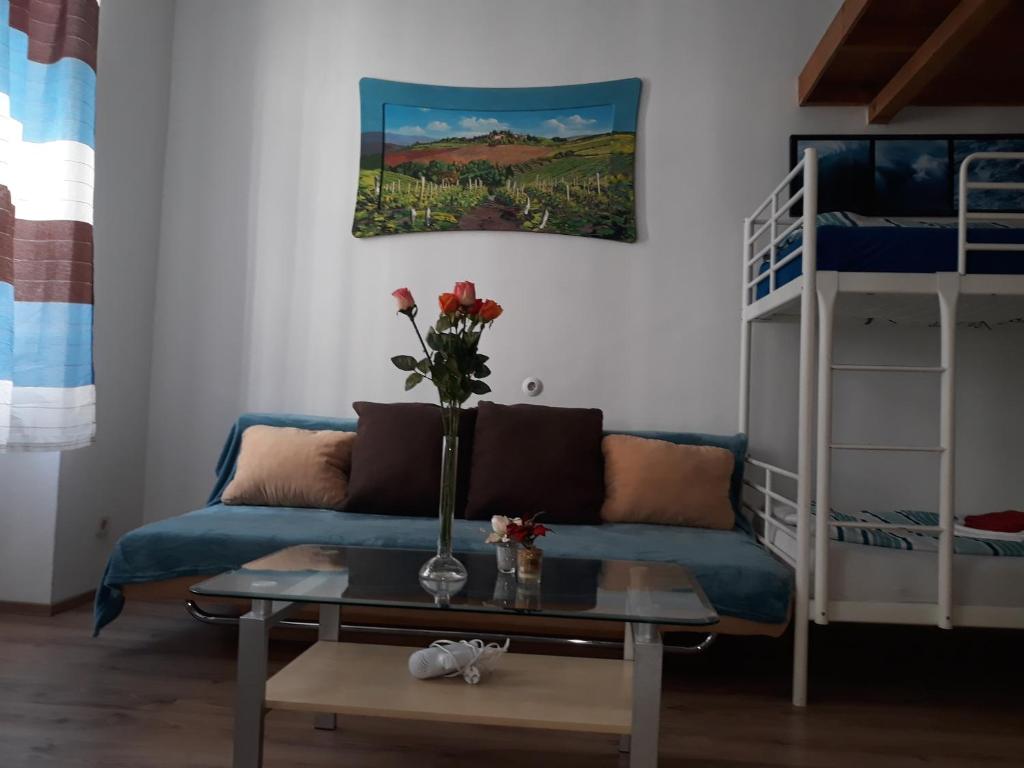 a living room with a couch and a table and a bunk bed at Monteapartments Vienna Belvedere 10 minutes to downtown in Vienna