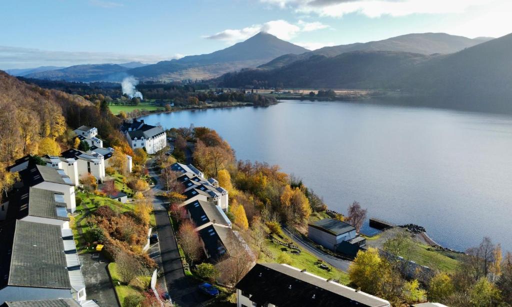an aerial view of a lake with mountains in the background at Loch Rannoch Highland Club in Kinloch Rannoch