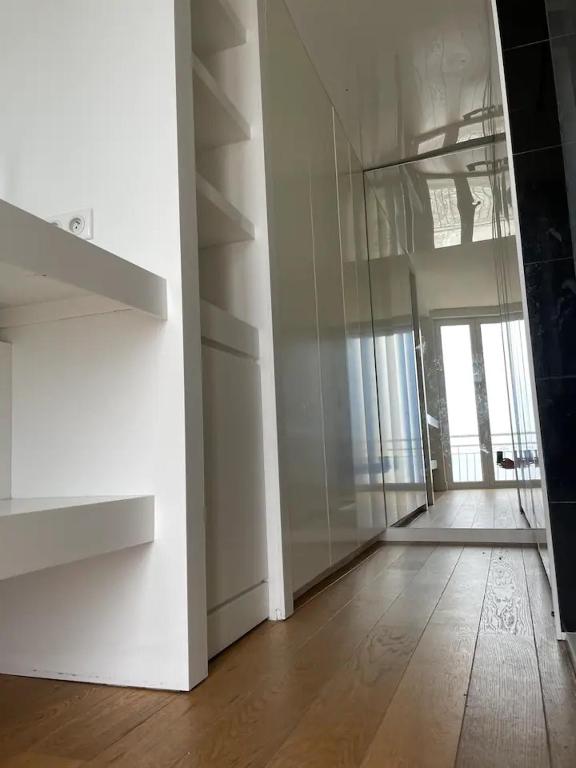 an empty room with a hallway with a glass door at CASA GUASCO superbe duplex au cœur de la Citadelle, vue à 360 in Bastia