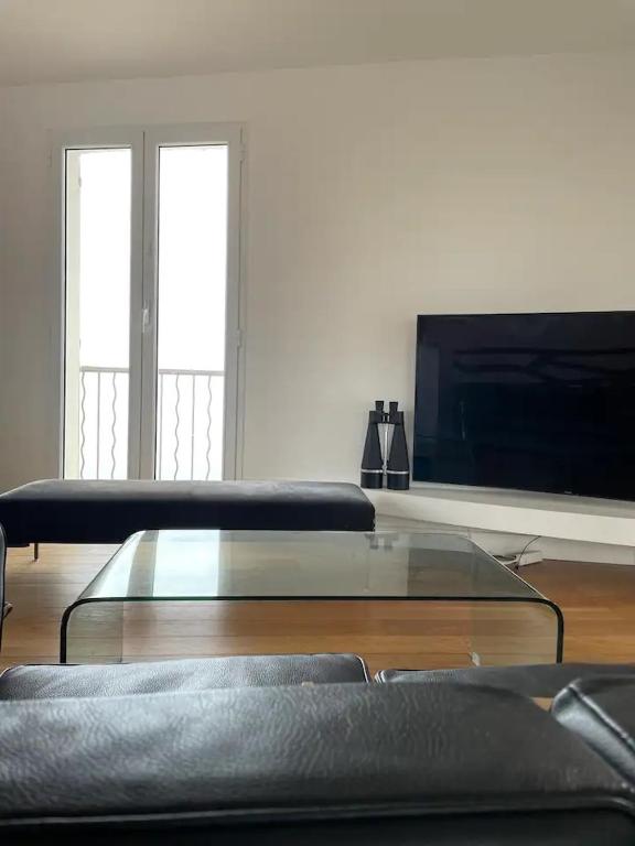 a living room with a couch and a glass coffee table at CASA GUASCO superbe duplex au cœur de la Citadelle, vue à 360 in Bastia