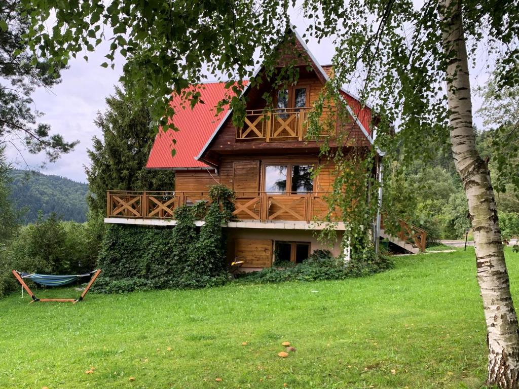 a log house with a red roof at Ada bieszczady in Baligród