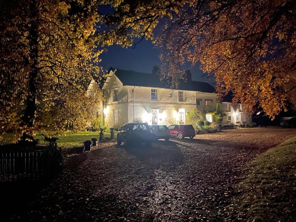 a car parked in front of a house at night at Old Rectory - Scoulton in Great Ellingham