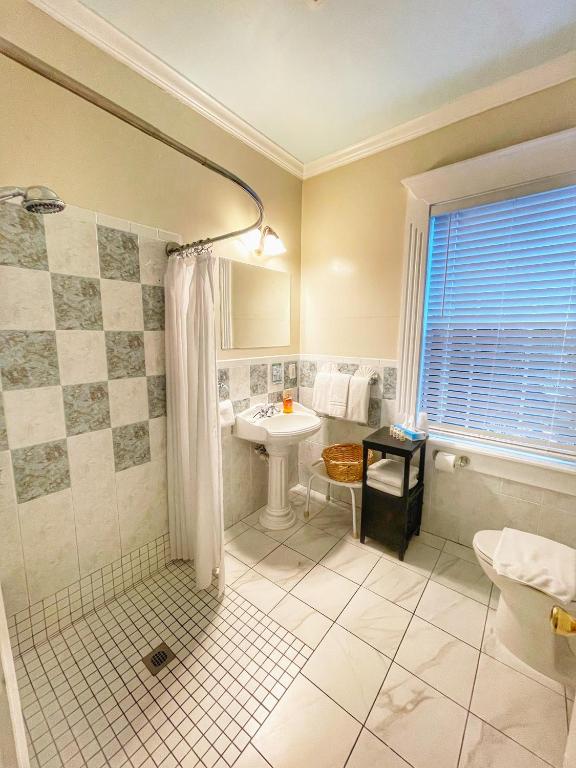 a bathroom with a shower and a sink at The Casablanca Hotel in Key West