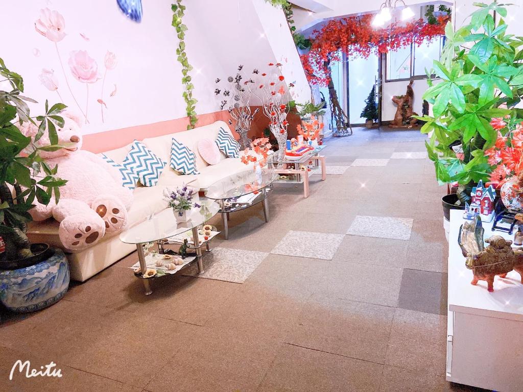 a living room filled with lots of potted plants at Yoshidoku Inn - Universal Studios 3 stops, Namba 2 stops, Shinsaibashi 3 stops in Osaka