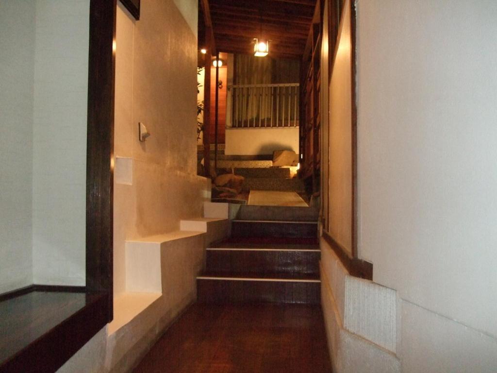 Postel nebo postele na pokoji v ubytování Marunaka Ryokan