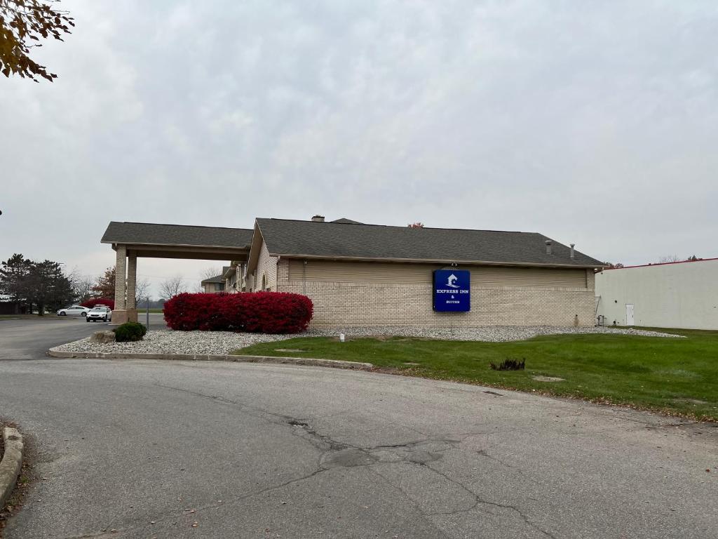 a house with a blue sign next to a street at Express Inn & suites in Decatur