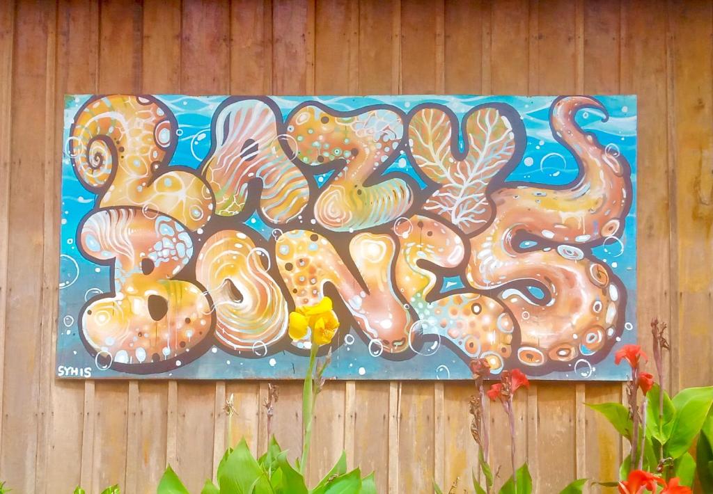a painting of octopus on a wooden wall at Lazy Bones in Koh Rong Sanloem