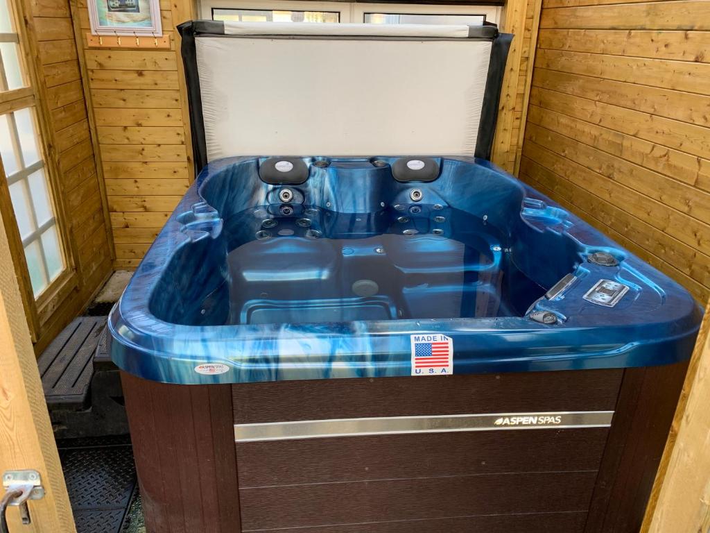 a jacuzzi tub sitting inside of a house at Relaxing home - 7-10min to Bournemouth sandy beach by car - private garden, parking and spa in Bournemouth
