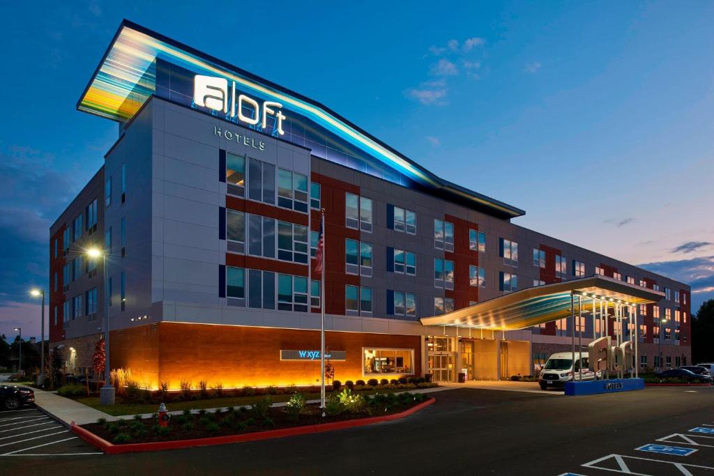 a hotel with a sign on the side of a building at Aloft Cleveland Airport in North Olmsted