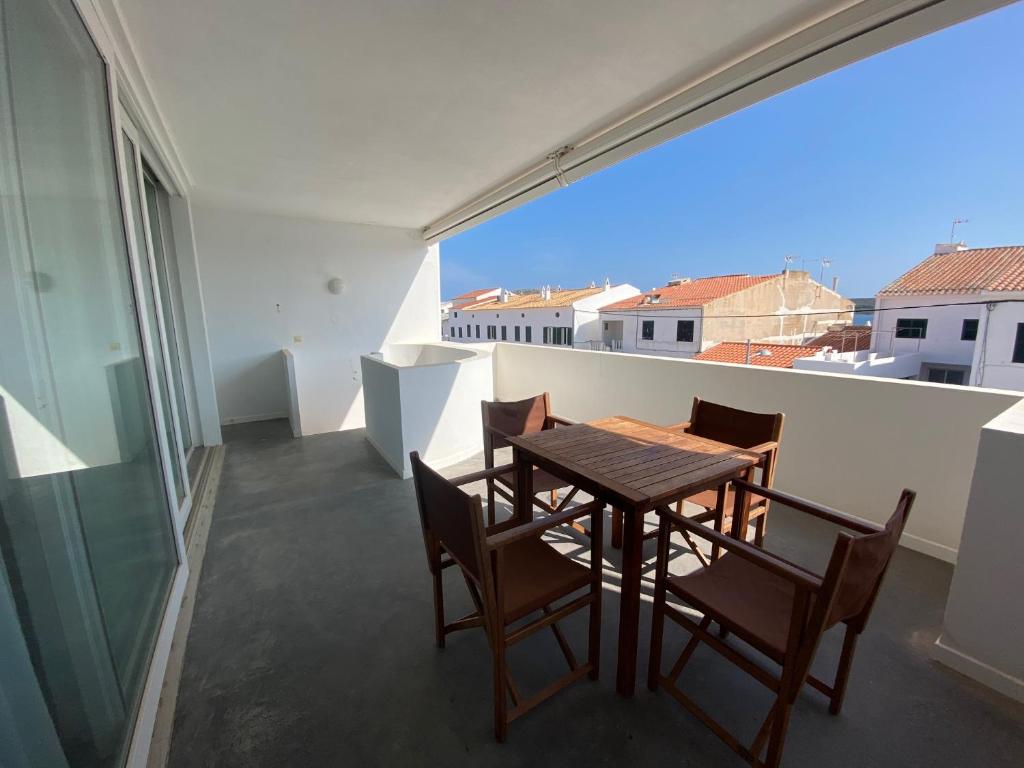 einen Tisch und Stühle auf einem Balkon mit Aussicht in der Unterkunft Riera Rossello 3 in Fornells