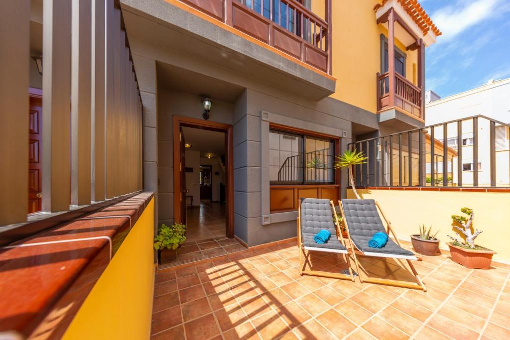 una sedia sul patio di una casa di MEDANO4YOU Las 3 Fridas a El Médano