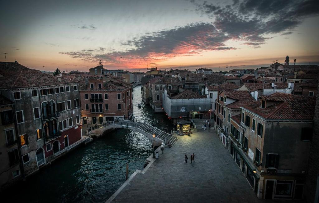 a view of a city with a bridge over a river at Alloggio Casa Loredan in Venice