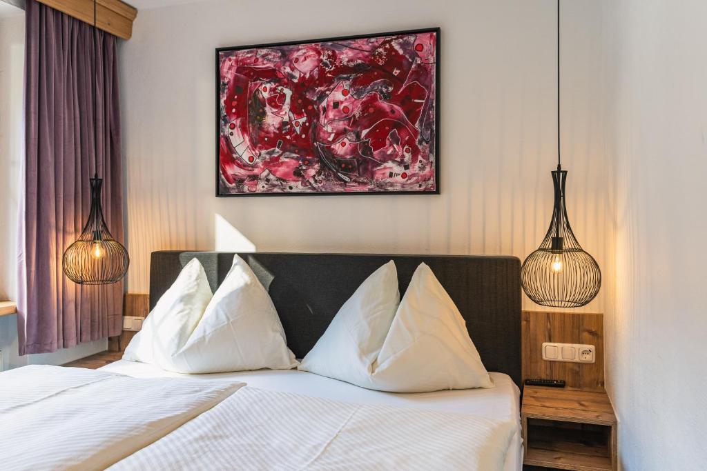 Postel nebo postele na pokoji v ubytování Hotel Der Schmittenhof