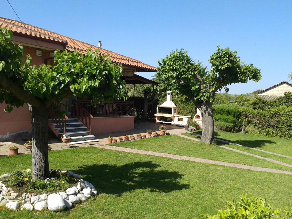 a yard with two trees and a building at Lovely cottage with garden !!!!! in Kariá
