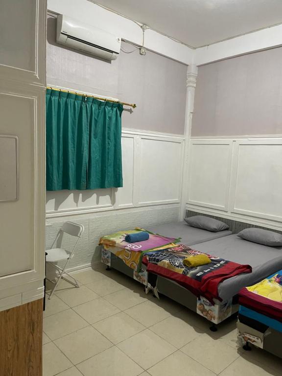 Postel nebo postele na pokoji v ubytování Mulia Homestay