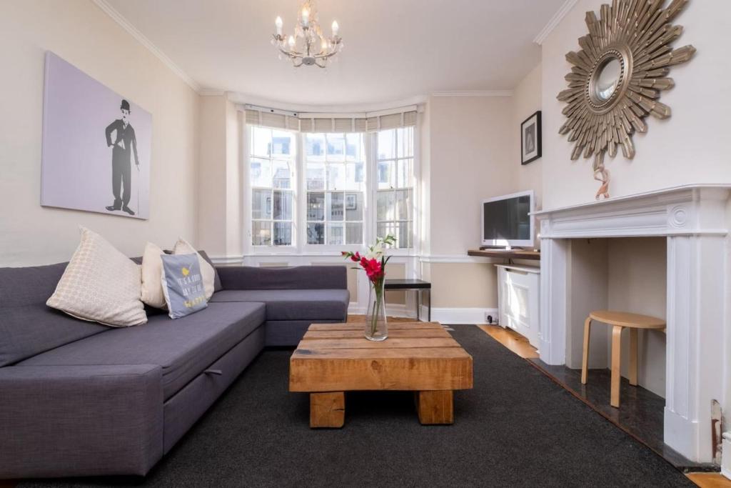 a living room with a couch and a table at Large Central Brighton Townhouse Close to Pier in Brighton & Hove