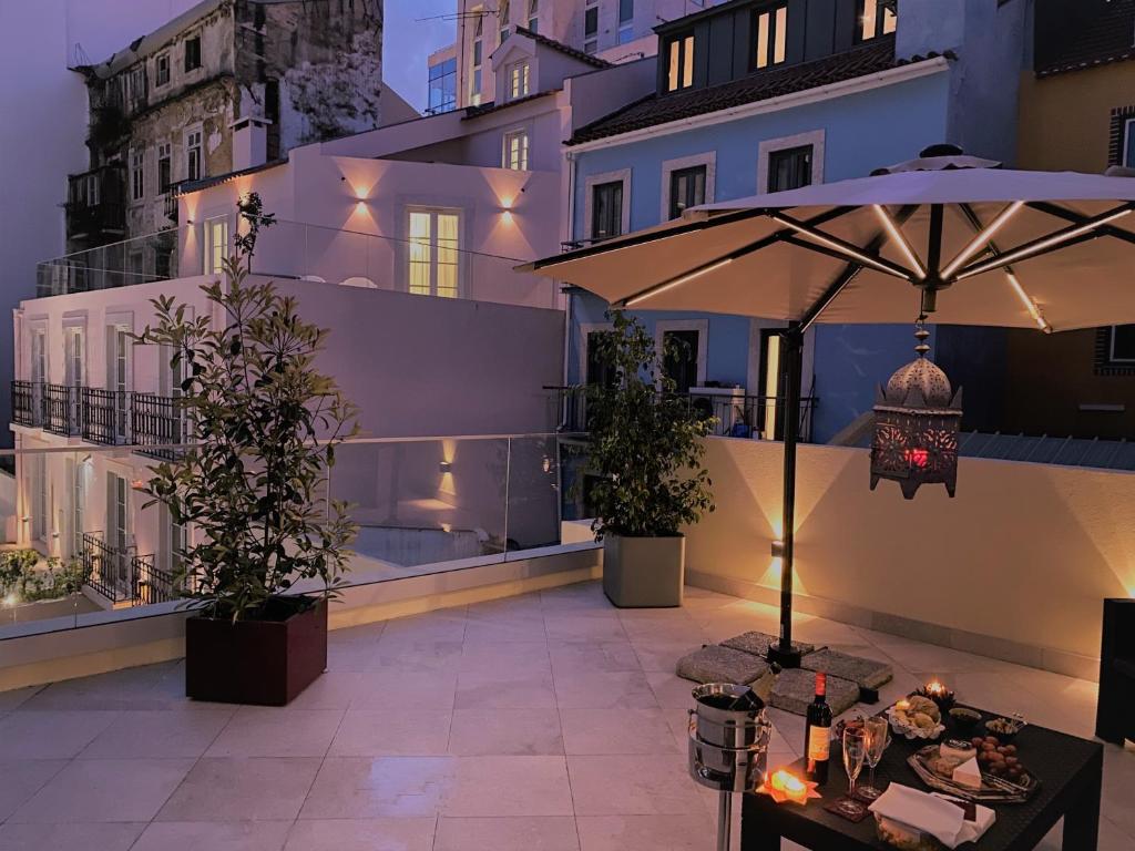 a patio with an umbrella and a table at TM Luxury Apartments Lisbon in Lisbon