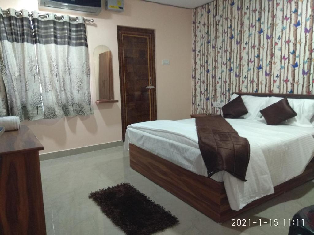 Postel nebo postele na pokoji v ubytování Sweety's Residency