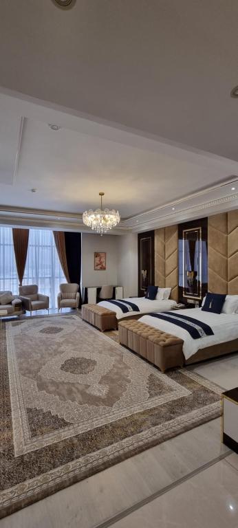 a large bedroom with two beds and a chandelier at Safo Dushanbe in Dushanbe