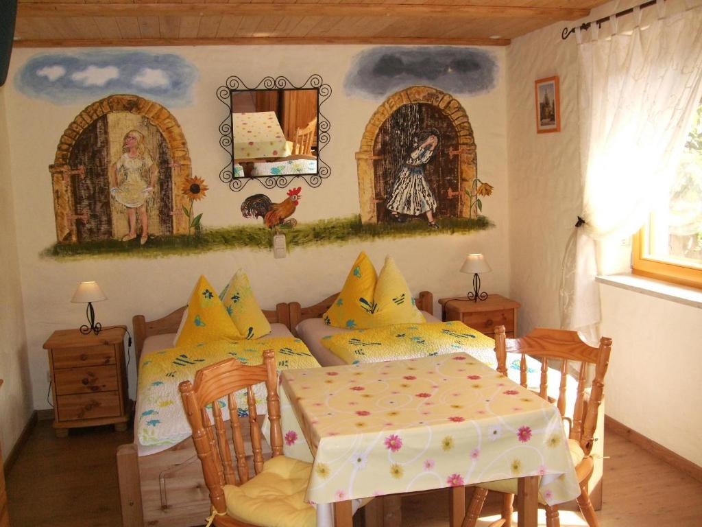 ein Esszimmer mit einem Tisch, einem Tisch und Stühlen in der Unterkunft Gästezimmer am Märchenbrunnen in Lockwitz