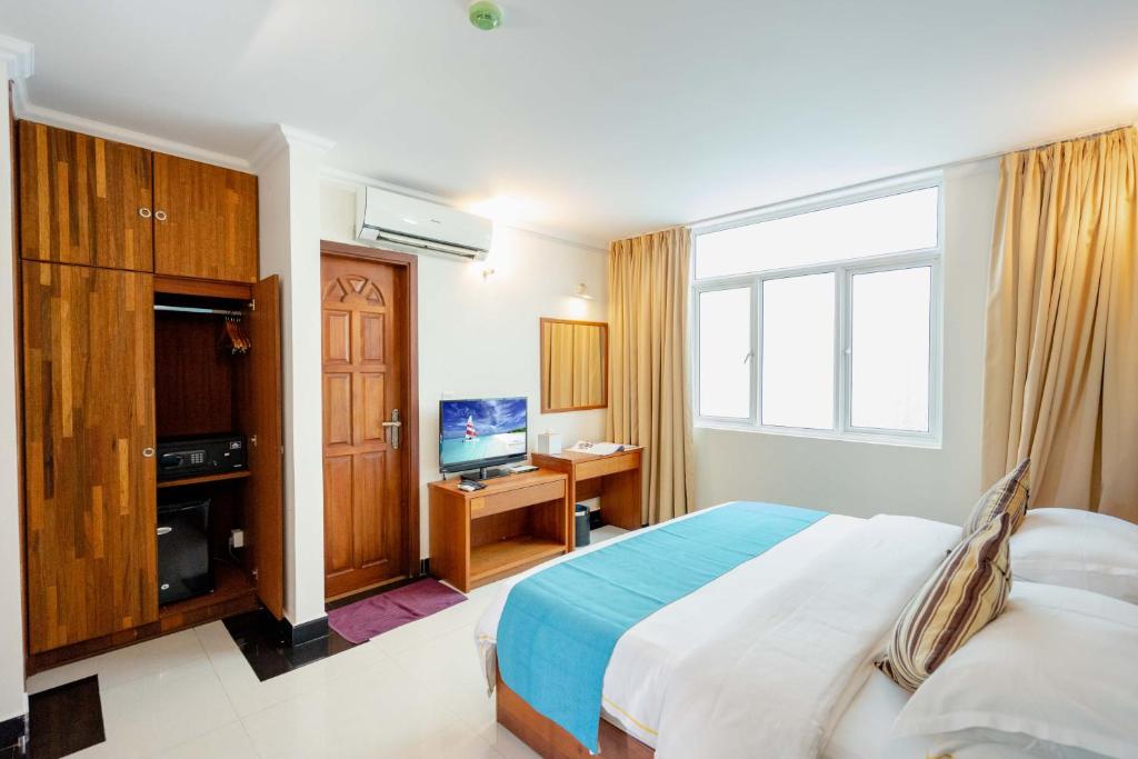 Postel nebo postele na pokoji v ubytování Noomoo Hulhumale