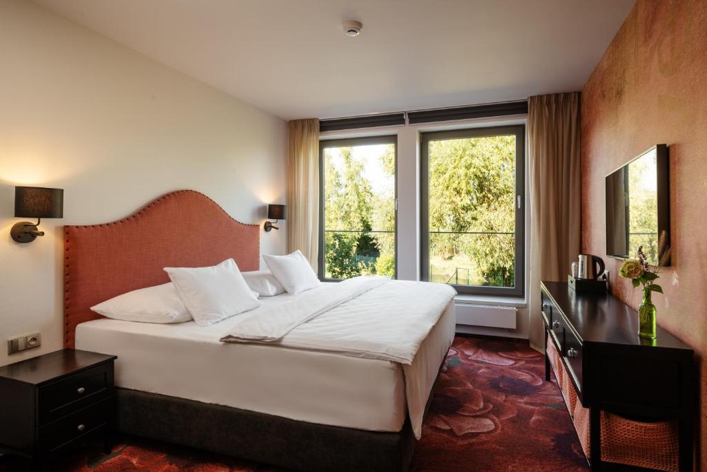 Postel nebo postele na pokoji v ubytování HERBARIUM boutique hotel