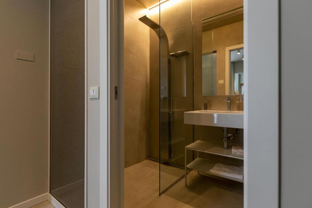 a bathroom with a sink and a shower at Attico Terrammare in Trapani