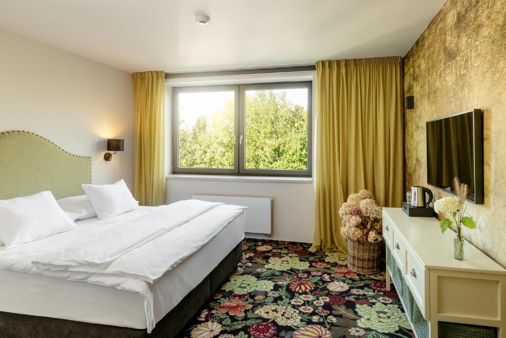 Postel nebo postele na pokoji v ubytování HERBARIUM boutique hotel