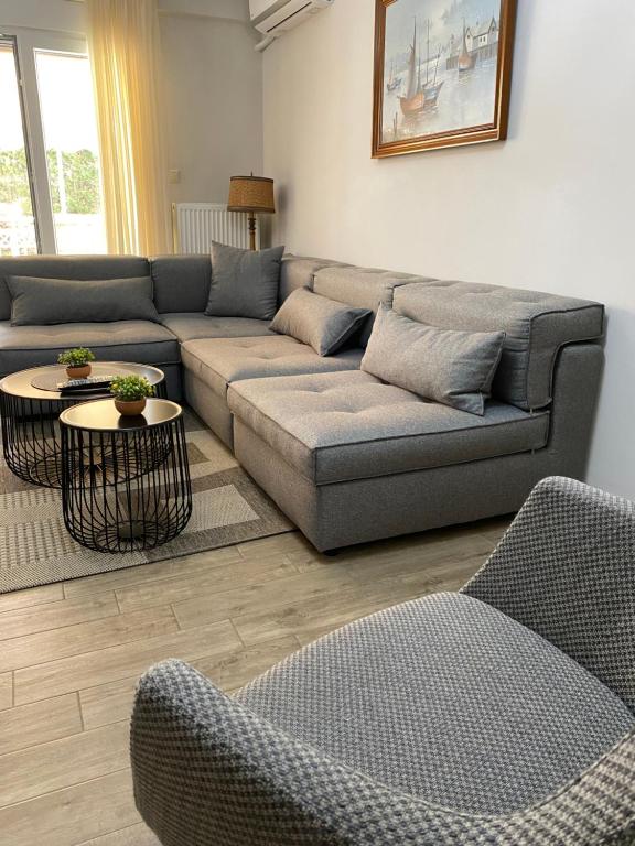 a living room with a couch and two chairs at Comfortable & quiet apartment 1 in Alexandroupoli