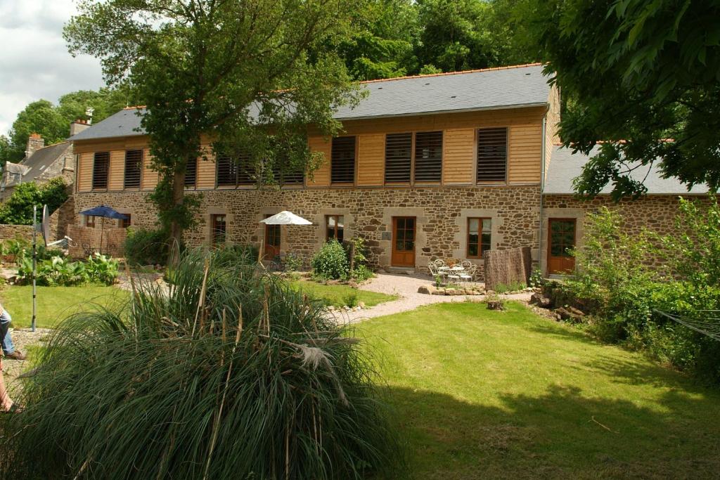 una gran casa de piedra con un patio delante en La Tannerie du Port, en Dinan