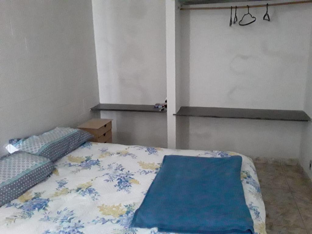 Un dormitorio con una cama con una manta azul. en Apartamento na Praia do Morro, en Guarapari