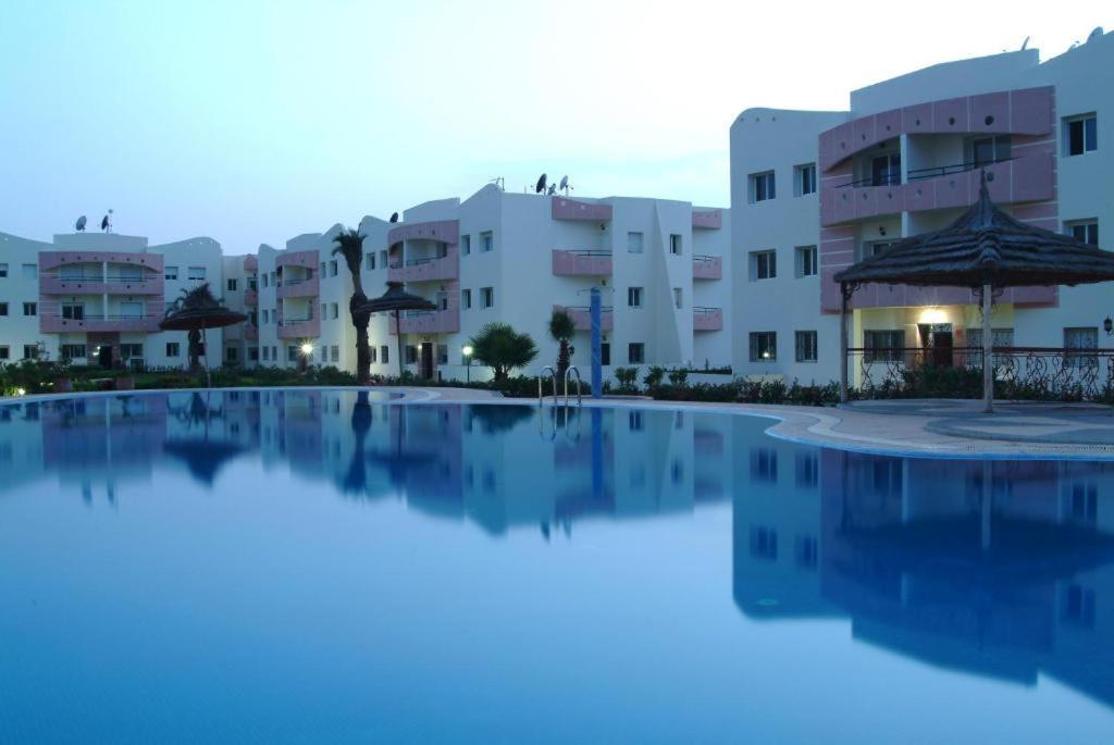 a large swimming pool in front of some buildings at Mohammedia résidence in Mohammedia