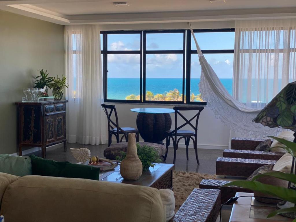 a living room with a view of the ocean at Janelas de Sol 400 in Fortaleza