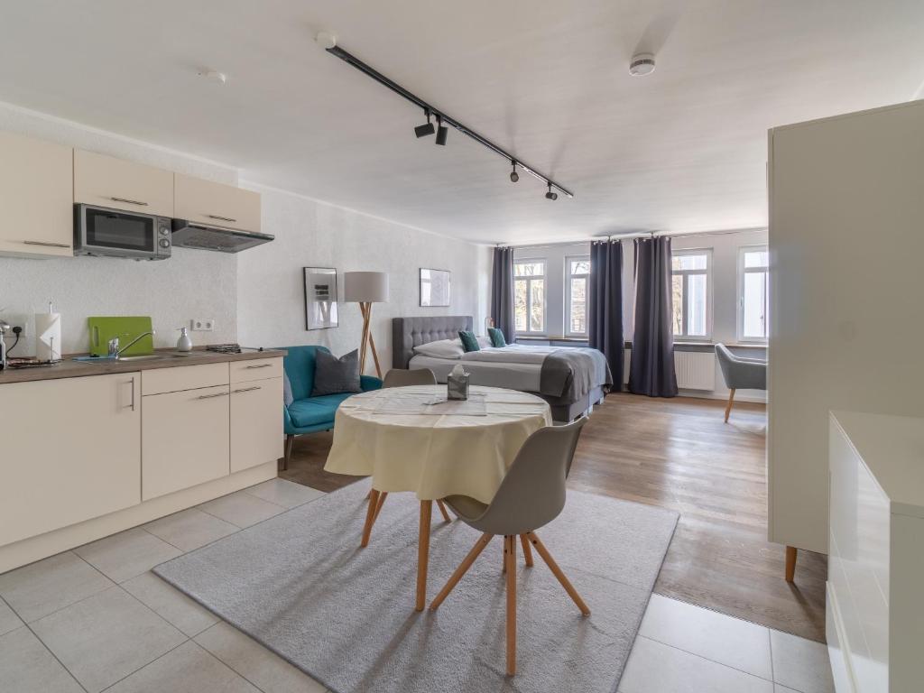 eine Küche und ein Wohnzimmer mit einem Bett und einem Tisch in der Unterkunft limehome Montabaur Kirchstraße in Montabaur