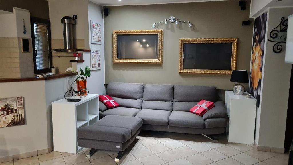 a living room with a couch and a tv at Chic & Relax apartment in Rimini