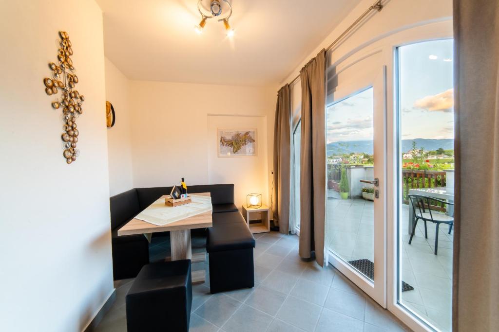 a dining room with a table and a balcony at Lochererhof in Appiano sulla Strada del Vino