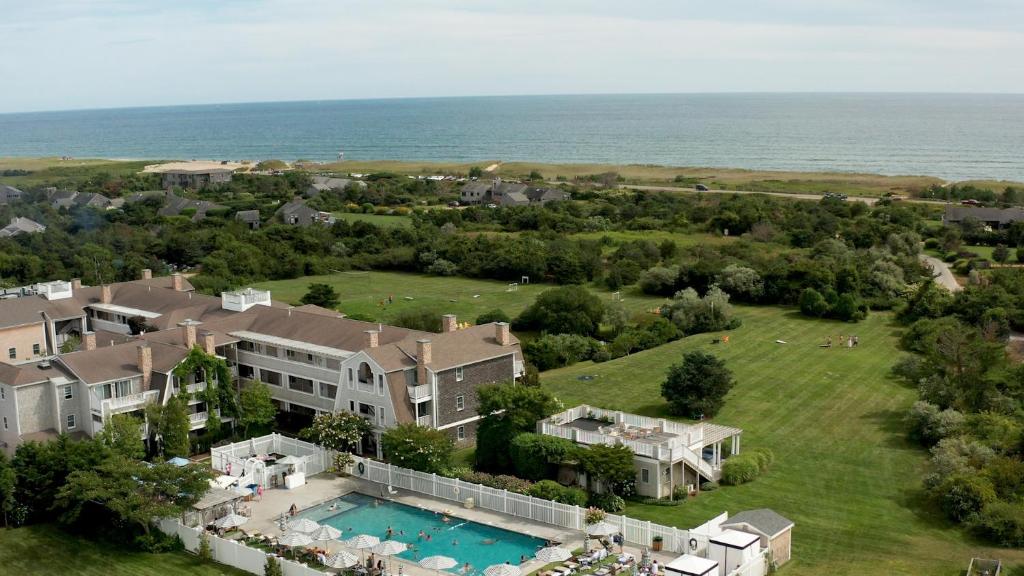 an aerial view of a large house with a swimming pool at Winnetu Oceanside Resort at South Beach in Edgartown