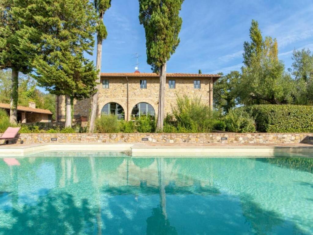 a large swimming pool in front of a house at Villa Popillo in Montaione