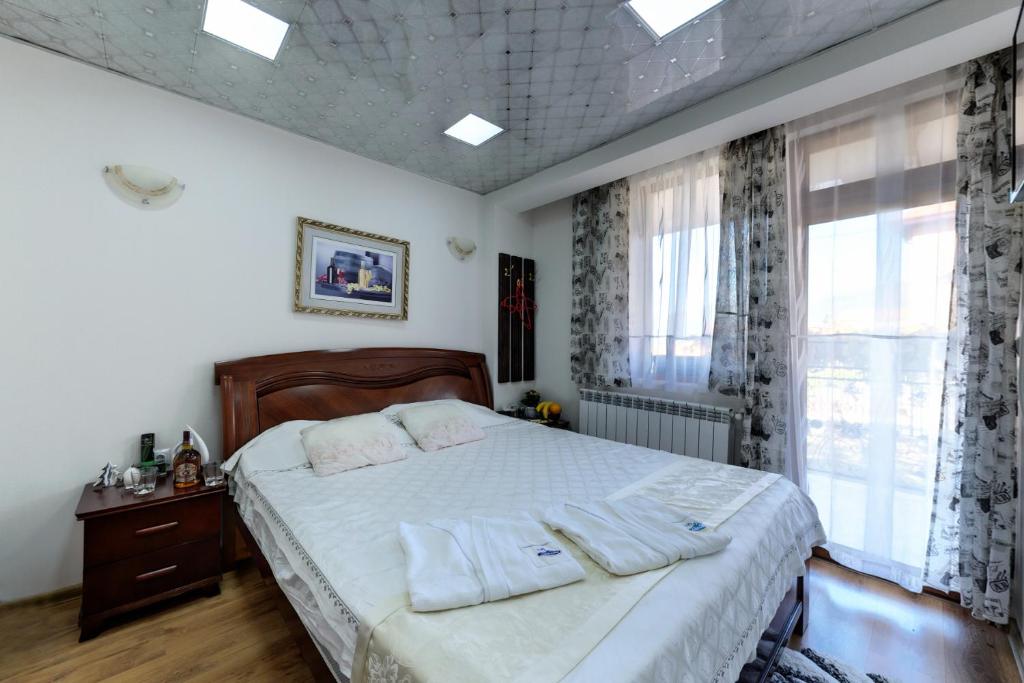 a bedroom with a bed with two pillows on it at Villa Koko Hills in Sapareva Banya