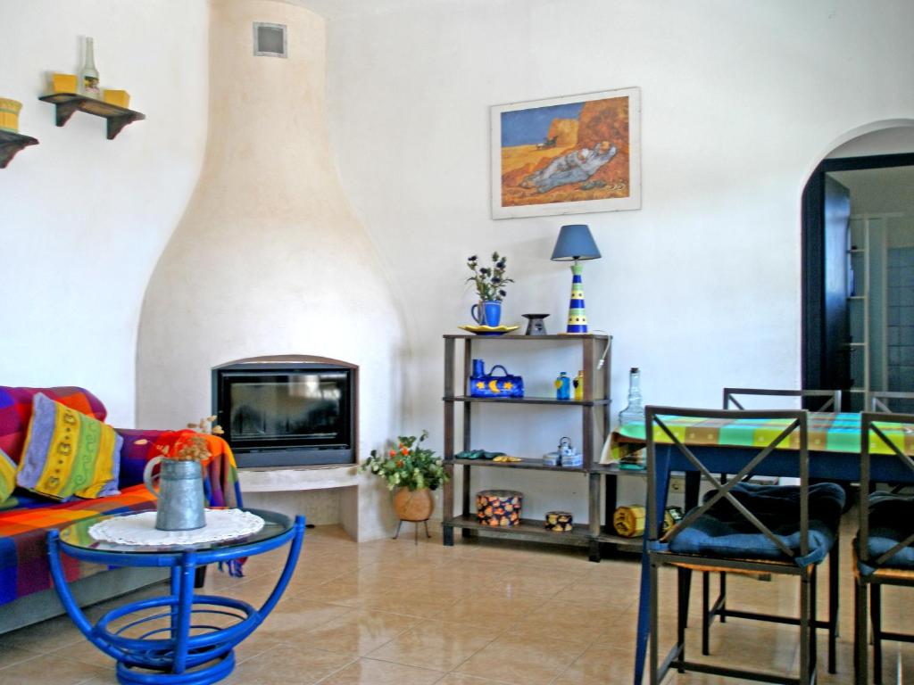 a living room with a couch and a fire place at Caseta de pescadors a les cales de Colera, 2ª linea de mar in Colera