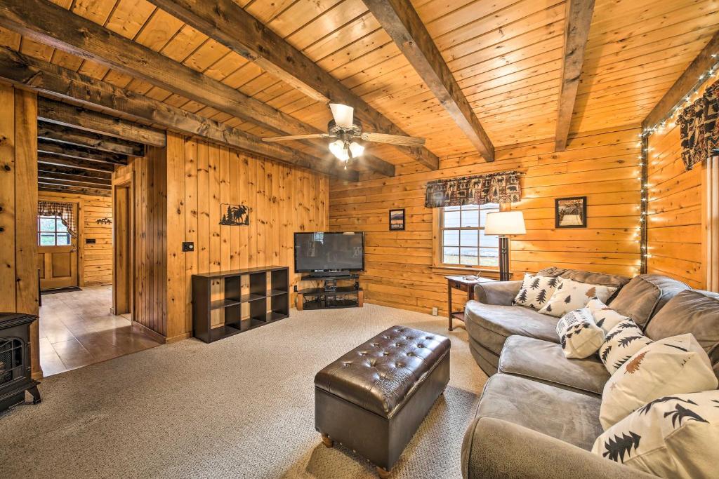 a living room with a couch and a tv at All-Season Sanctuary Steps to Moosehead Lake in Greenville