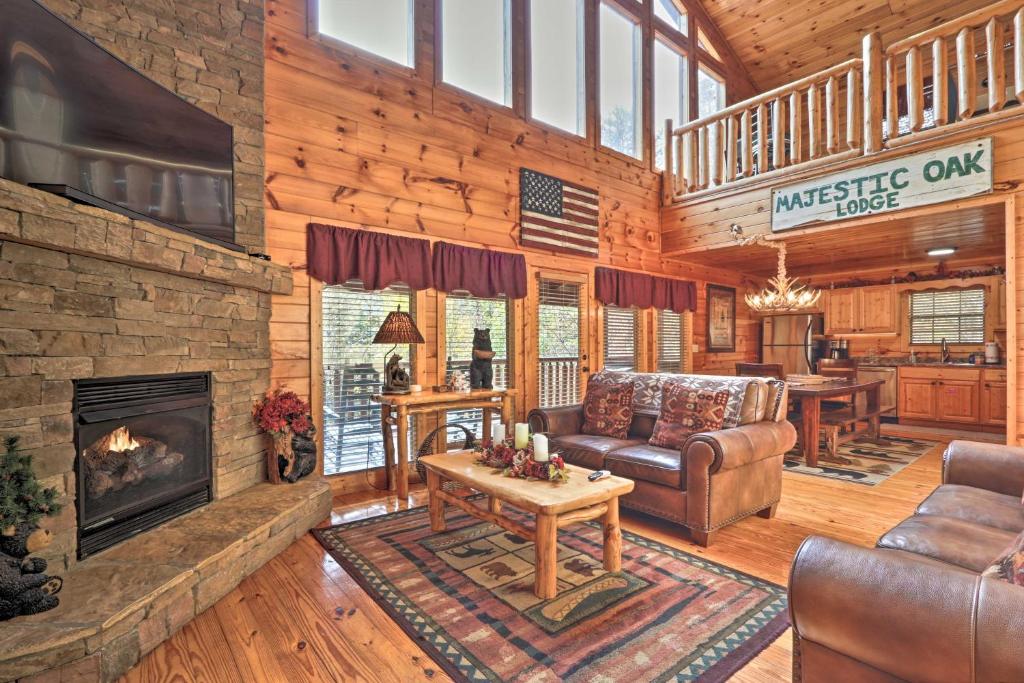 a living room with a couch and a fireplace at Woodsy Retreat with Hot Tub, 8 Mi to Dollywood! in Sevierville