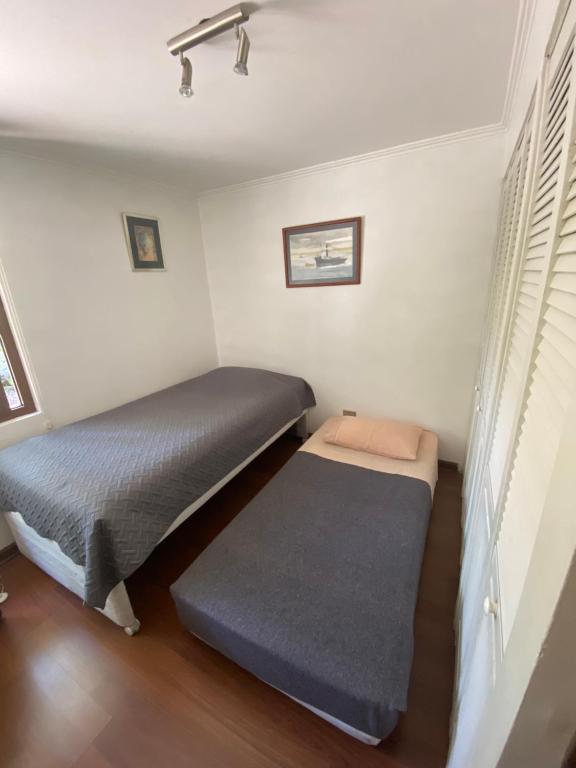 1 dormitorio con 2 camas y ventana en Nido de Condores en Santiago